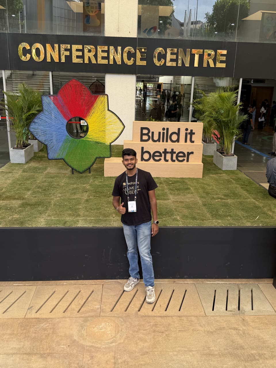 Kanish at the Conference Centre entrance, in front of a Build it better sign
