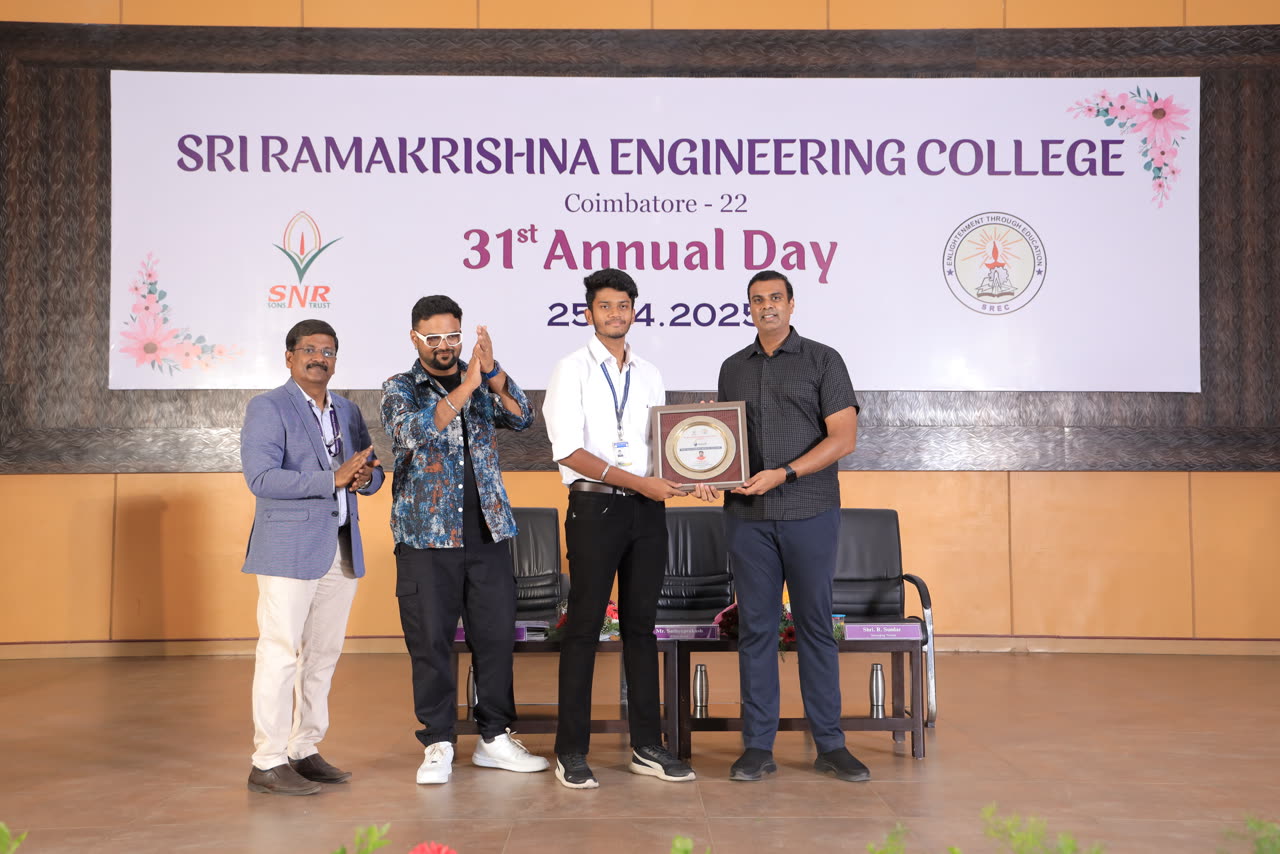 Kanish receiving the ABARAM plaque on stage at the 31st Annual Day