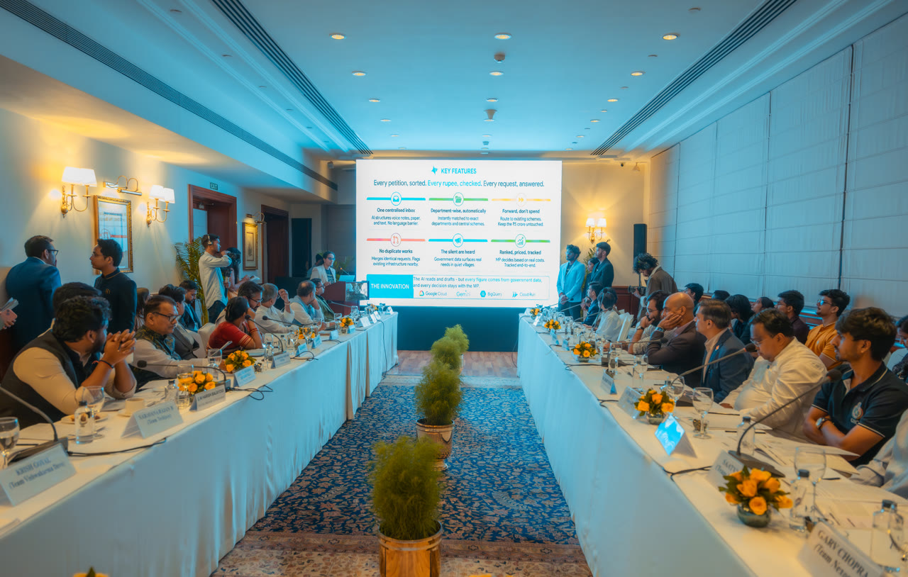 The key features slide, with MPs seated along both tables