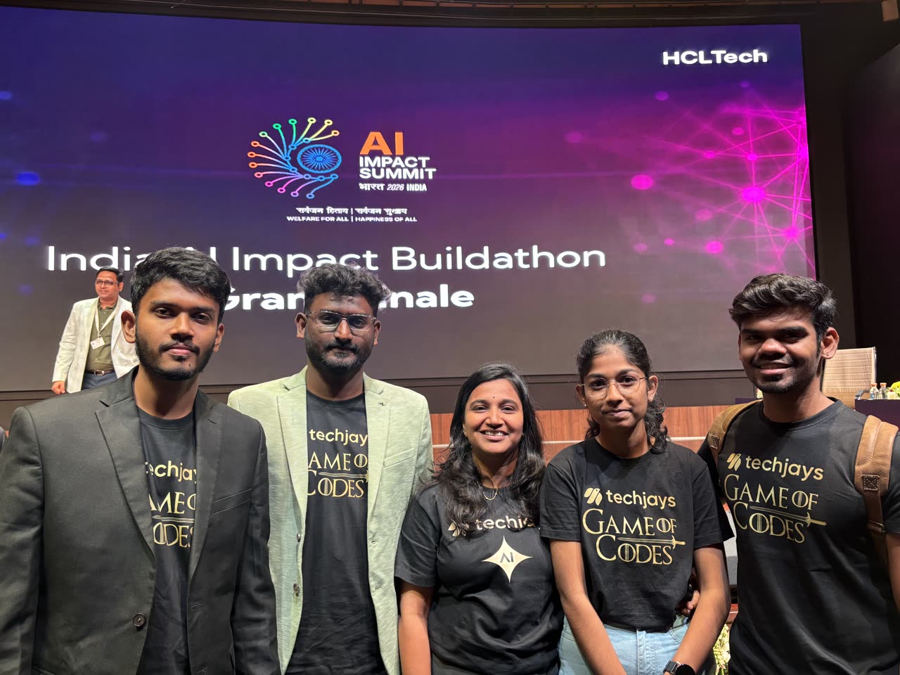 Team Techjays in front of the Grand Finale screen