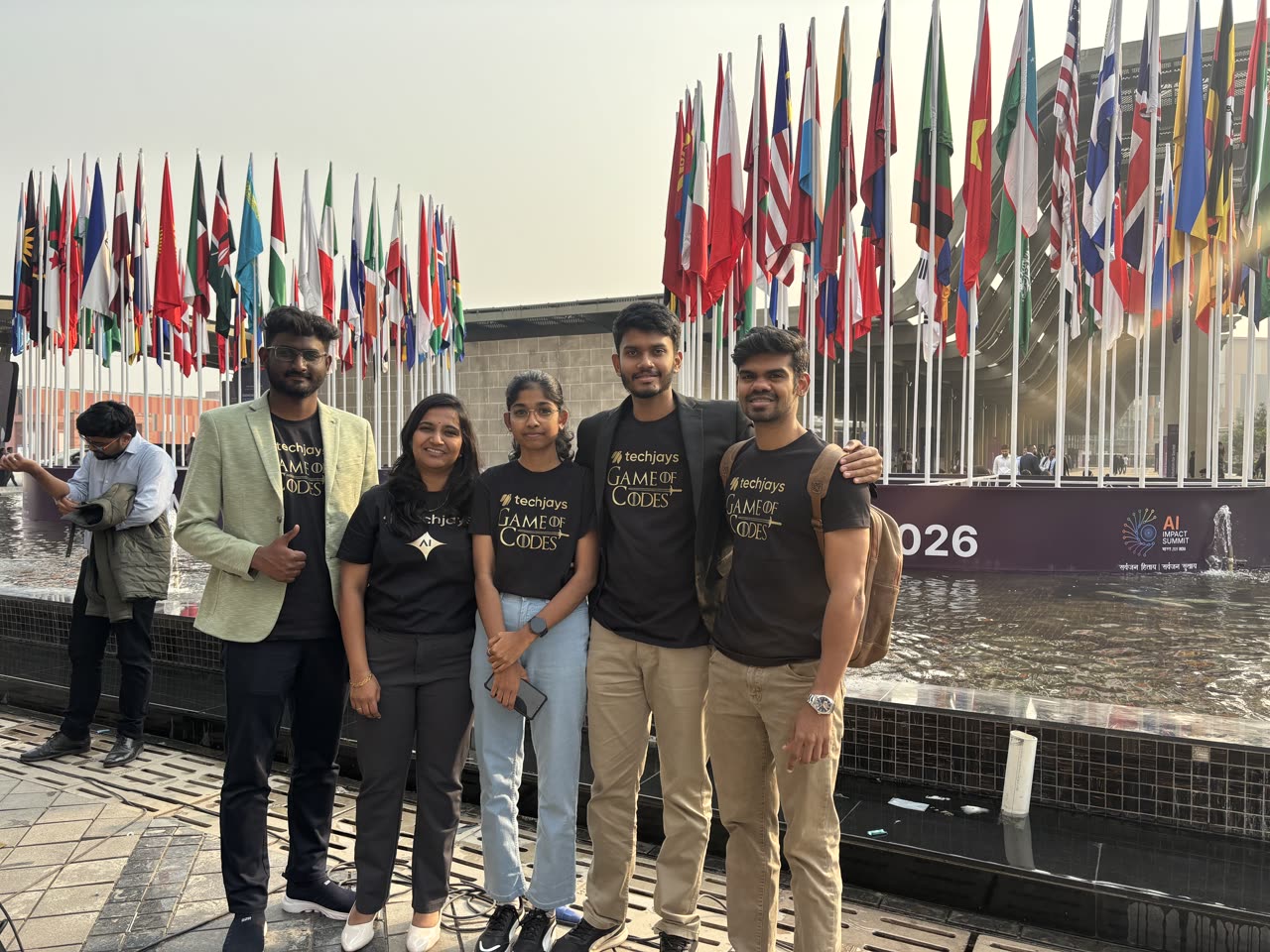The team by the ring of flags at the summit venue